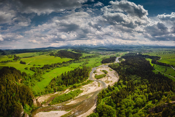 Drone photo of Bialka River with view to the Tatra Mountains- spring season with pretty colours