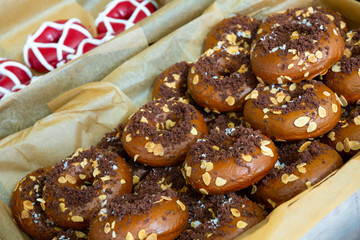 Assorted donuts in box glazed and decorated. Fresh pastry