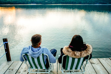 young couple sitting on chair on pontoon