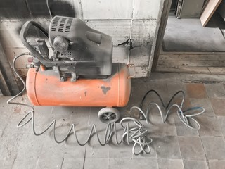 Air compressor for blowing, inflating tires, painting. Set of pneumatic tools in garage for pumping...