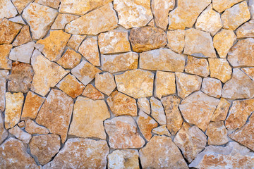 Rock material wall from exterior of a traditional house. Typical contruction structure made of stone. 