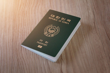 Republic of Korea passport on wooden texture
