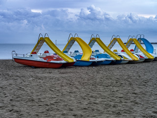 Deserted beach landscape with pedal boats