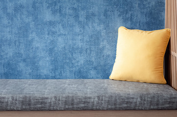 relaxing corner at home, gray cushion with pillows on blue background