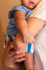 Young mother holding her newborn baby boy.