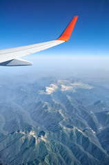 Plane wing on the background of Western Caucasus mountains. Adygeya, Russia.