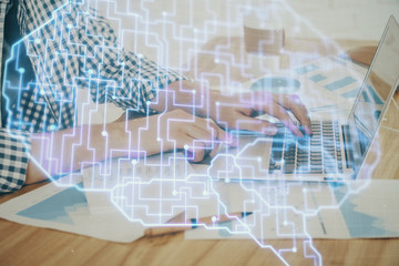 Man typing on keyboard background with brain hologram. Concept of big Data. Double exposure.