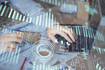 Technology theme hologram with man working on computer on background. High tech concept. Multi exposure.