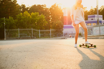 Fototapeta na wymiar Young woman riding a skateboard in the city