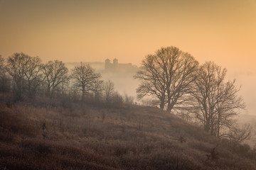 Fototapeta na wymiar Tyniec abbey in morning fog in sunrise time. Cracow, Malopolska, Poland 