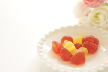 red and yellow gummy jelly candy on white dish
