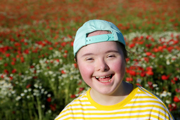 Young girl on the background of flowers field