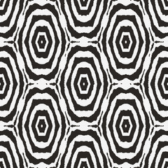 Black and white seamless vector abstract pattern with target shapes mosaic. Unisex graphic surface print design for fabrics, textiles, backgrounds, stationery, gift wrap, and packaging.