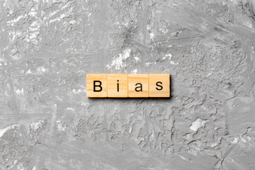 BIAS word written on wood block. BIAS text on cement table for your desing, concept
