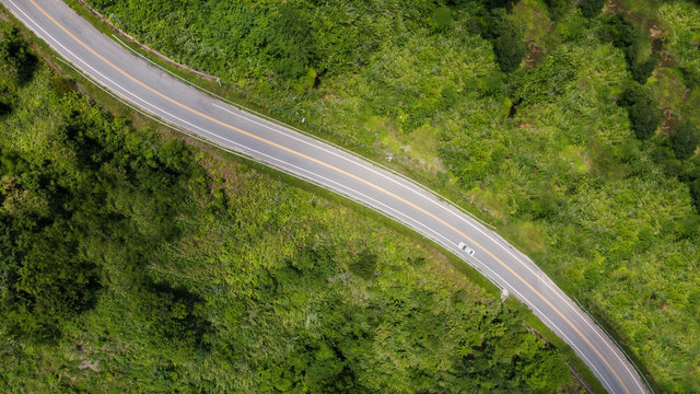 Nan, Thailand. Aerial view of Beautiful sky road over top of mountains with green jungle. Road trip on curve road in mountain. © Vajirawich