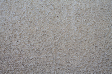 Texture of dirty old rough plaster on an exterior wall.