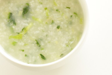 Chinese food, spinach and rice porridge in white bowl