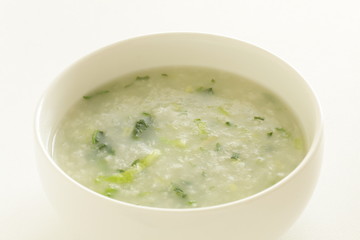 Chinese food, spinach and rice porridge in white bowl