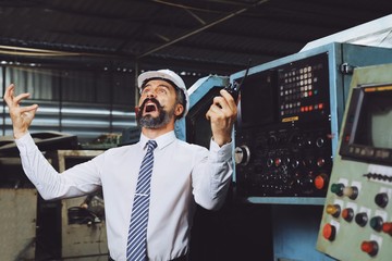 Crazy Manager wearing helmet walking in factory for checking system of machine, Young man upset in...