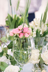 The wedding decor. Table set for an event party or wedding reception. Beautiful flowers on table.