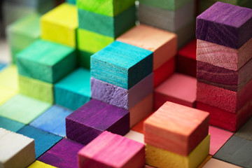 Spectrum of stacked multi-colored wooden blocks. Background or cover for something creative,...