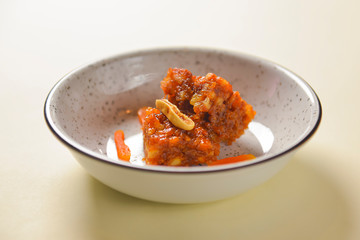 Novey and nuts dessert. Sweet caramel dessert in a bowl over pastel yellow background. Delicious tasty food.