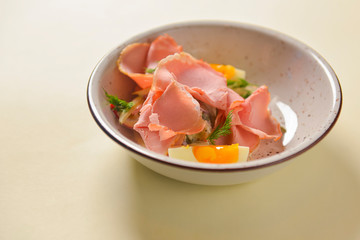 Boiled eggs with smoked ham and vegetables. Healthy vegetarian diet. Veggies salad.
