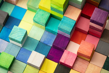 Spectrum of stacked multi-colored wooden blocks. Background or cover for something creative,...