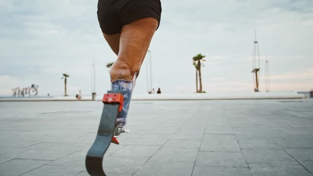 Close up view on running disabled woman with prosthesis
