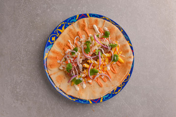 Lavash bread with grilled meat, vegetables, cheese. Shawarma lavash bread, fresh roll of lavash, pita bread.