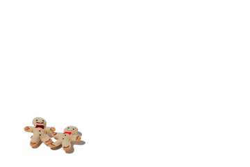 Textile handmade Gingerbread men are on the white isolated background. Copy space. Blank