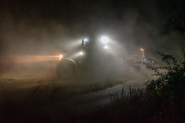 Traktor bestellt ein Feld in der Nacht