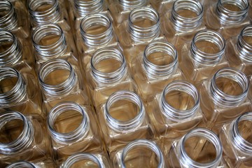 Clean plastic bottles stacked in a factory.
