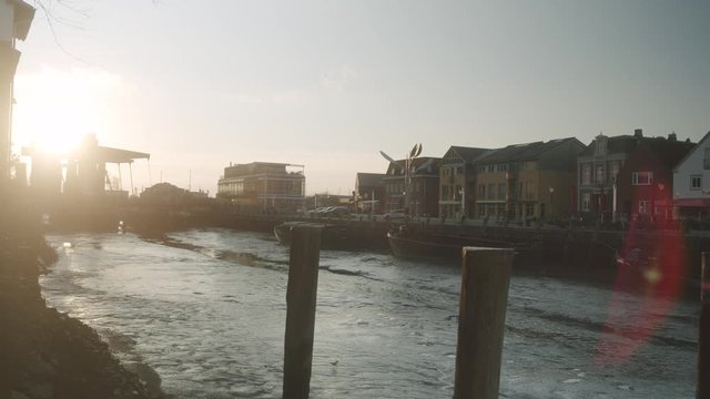 Panoramic View with Sun-flares Of Harbor In German Coast Town Husum At Sunset