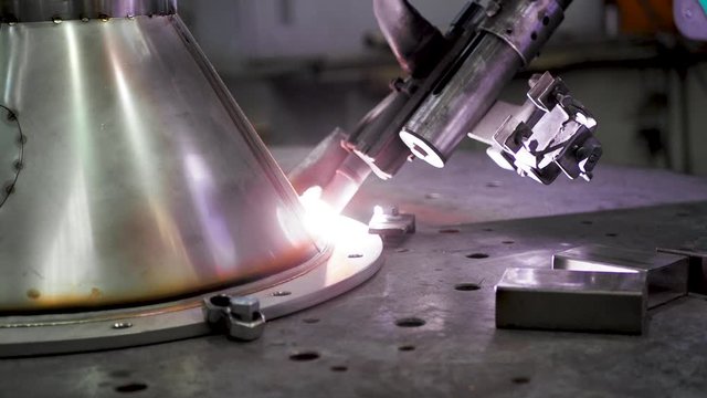 Automation welding mechanical procedure. Metal iron laser argon welding robot in factory. Automation of work. Slow motion. Close up