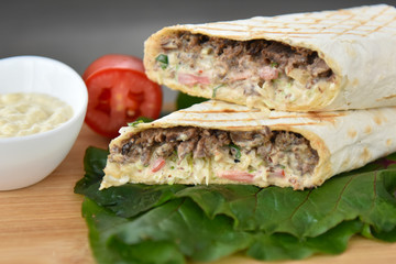 kebab meat with vegetables on a wheat tortilla