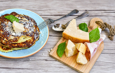 Bakery. Home made pancakes with   organic eggs , parmesan cheese,  italian   bacon and fresh basil on wooden background. Rustic style  ketogenic breakfast.