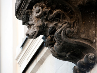 Face of a sculptural support of an old building in Lviv Ukraine