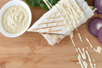 kebab meat with vegetables on a wheat tortilla