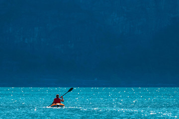 Woman sea kayaking in Norwegian fjord