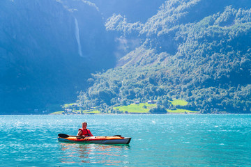 Woman sea kayaking in Norwegian fjord