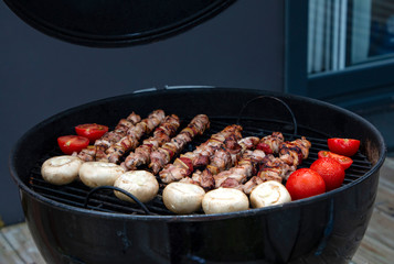 Assorted meat from chicken and various vegetables on barbecue grill