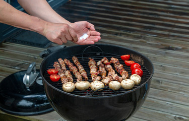 Assorted meat from chicken and various vegetables on barbecue grill