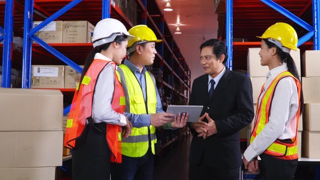 Warehouse manager and workers discussing business with businessman. logistics and delivery. Successful business negotiation.