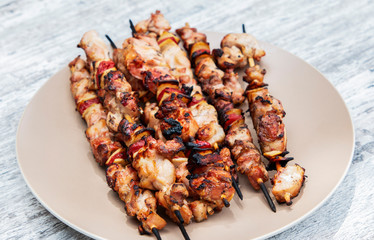 Grilled chicken on bamboo skewers, close up view