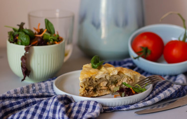 Still life with a vase and flowers, meat pie and tomatoes