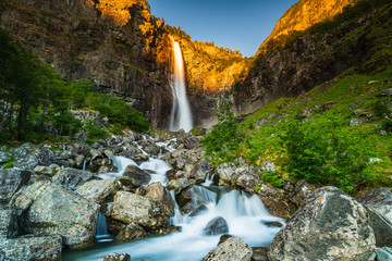 Fototapeta na wymiar Beautiful Norwegian waterfall at sunset