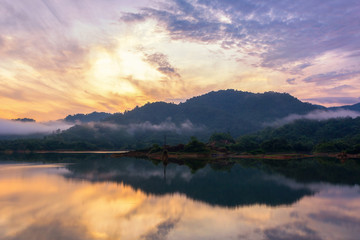 Fototapeta na wymiar Beautiful landscape morning with rising sun on lake at Hat Som Paen