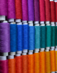 colourful thread rolls arranged in a box