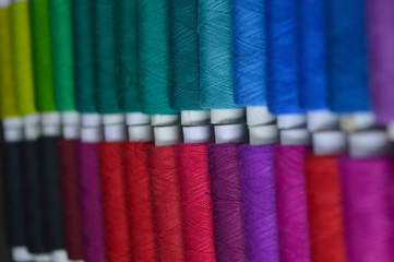 colourful thread rolls arranged in a box